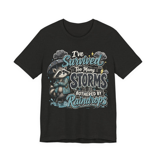 Survived Too Many Storms Tee — Inspirational Raccoon Rainy Day Graphic T-Shirt