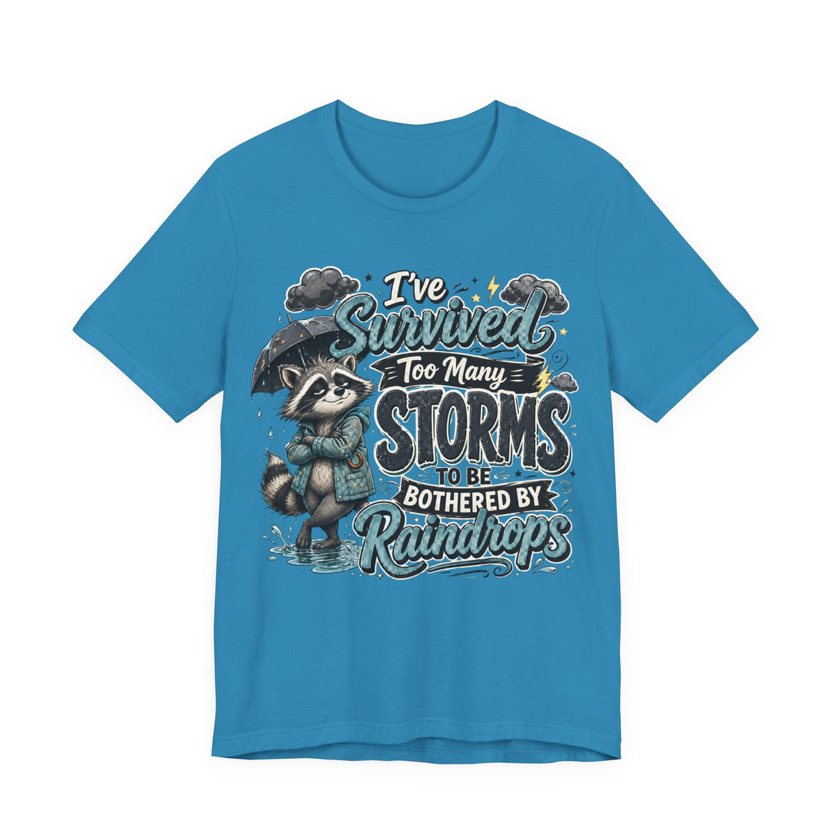 Survived Too Many Storms Tee — Inspirational Raccoon Rainy Day Graphic T-Shirt