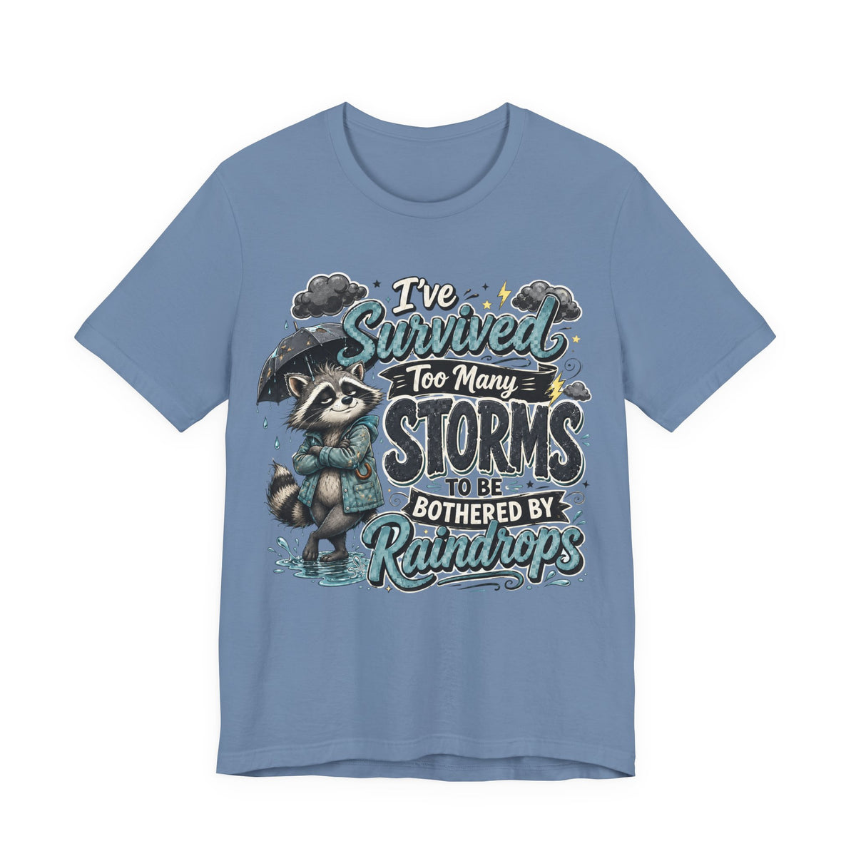 Survived Too Many Storms Tee — Inspirational Raccoon Rainy Day Graphic T-Shirt