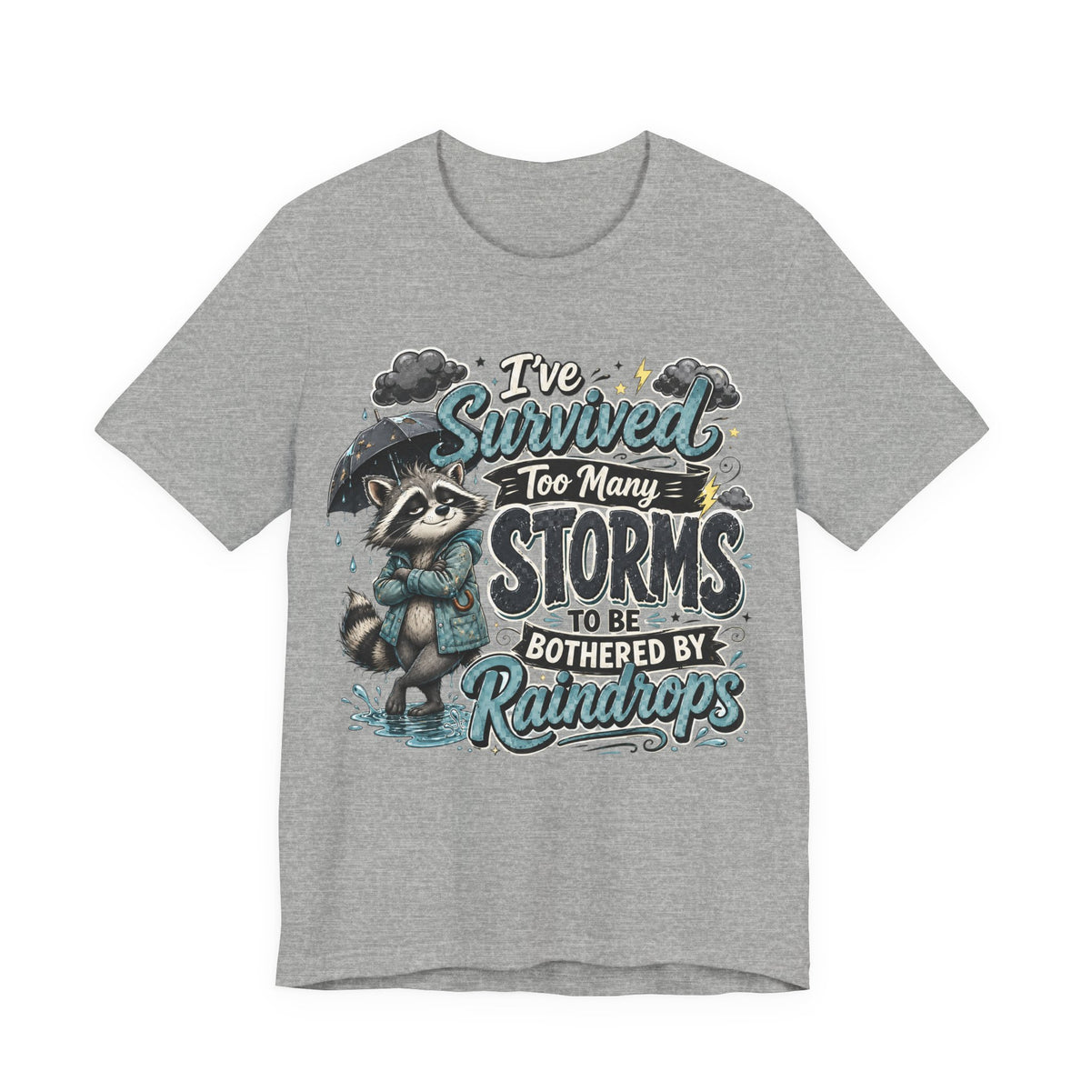 Survived Too Many Storms Tee — Inspirational Raccoon Rainy Day Graphic T-Shirt